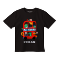 A black short-sleeve t-shirt with a colorful graphic of a double-decker bus carrying cartoon characters, with the text 'ALL ABOARD' and 'ROHAN' printed below it.