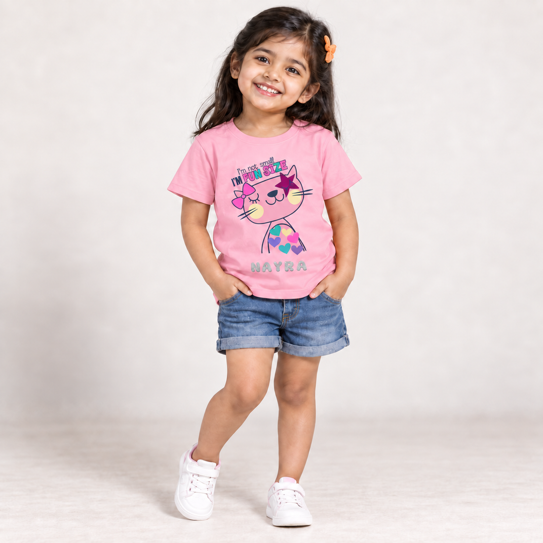 4-year-old Indian girl wearing a personalised baby-pink Fun Size cat T-shirt with the name NAYRA.